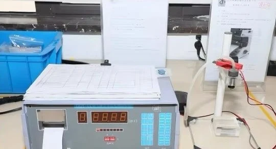 A coating thickness gauge used during inspection of plated metal components.