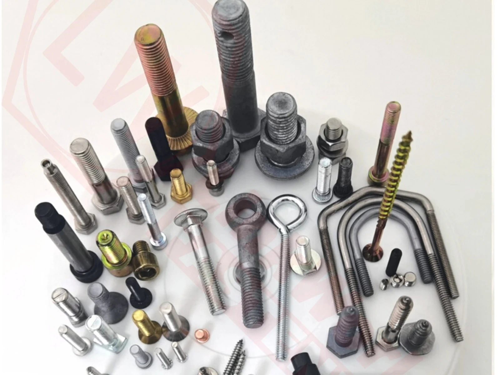Various custom bolts, threaded parts and special fasteners shown on a light surface.